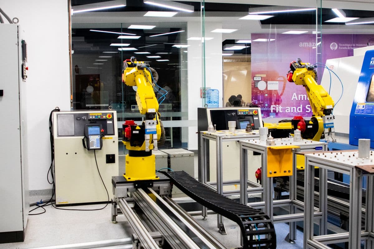 Automated robotic systems operating in a modern manufacturing facility - representing AI-powered computer vision quality control on the factory floor