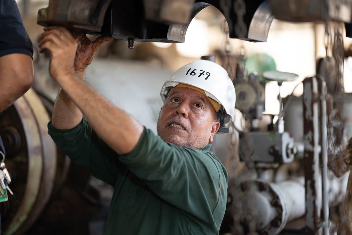Engineer inspecting industrial machinery in a manufacturing plant - representing AI-powered predictive maintenance and condition monitoring