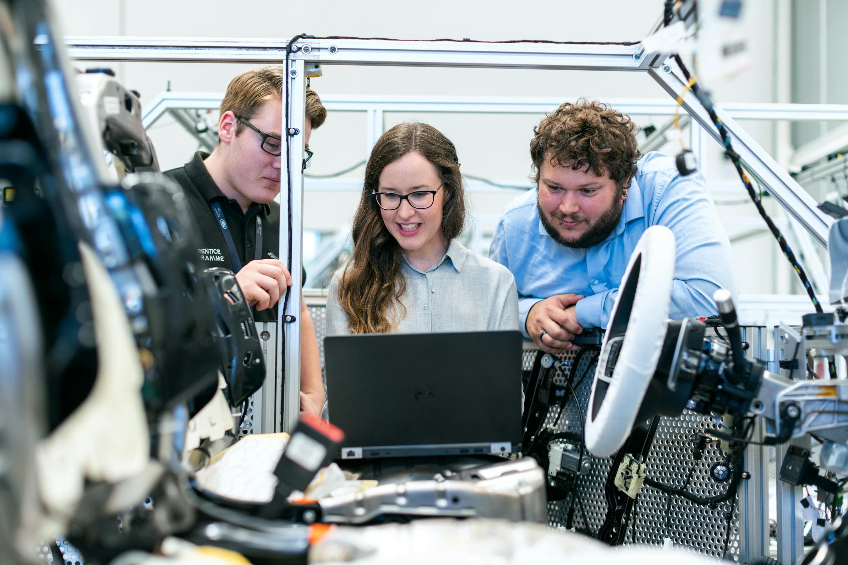 Engineers collaborating on a workshop laptop – AI-driven matching engine for a manufacturing connector marketplace